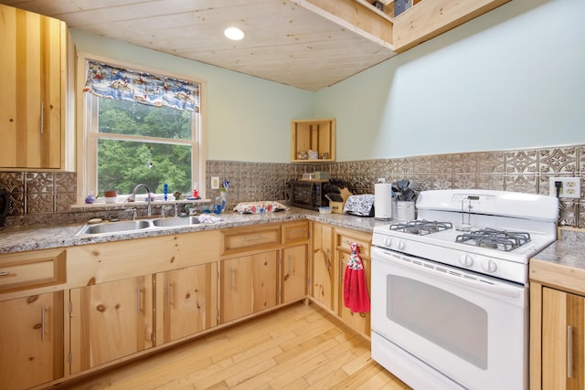 kitchen with light hardwood / wood-style floors, wood ceiling, white gas range, and sink