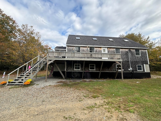 rear view of house with a yard and a wooden deck