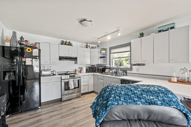 kitchen with white cabinetry, light hardwood / wood-style flooring, track lighting, and black appliances