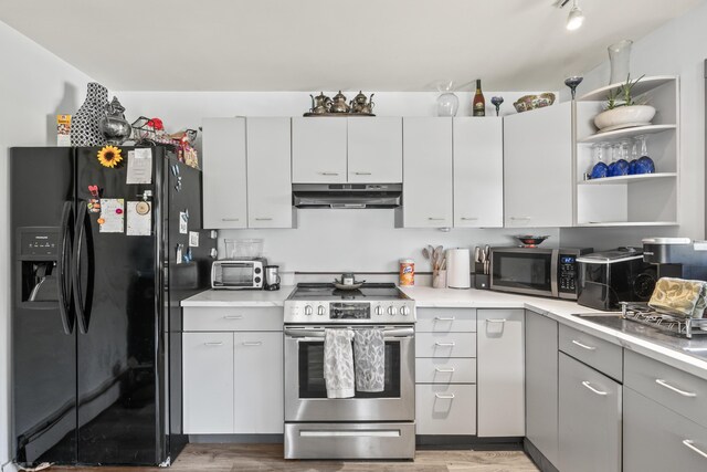 kitchen with hardwood / wood-style floors, stainless steel appliances, and gray cabinets