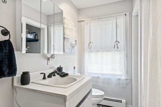 bathroom with vanity, a baseboard heating unit, and toilet