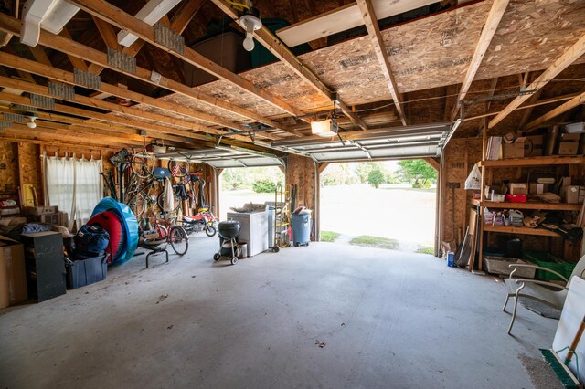 garage with separate washer and dryer and a garage door opener