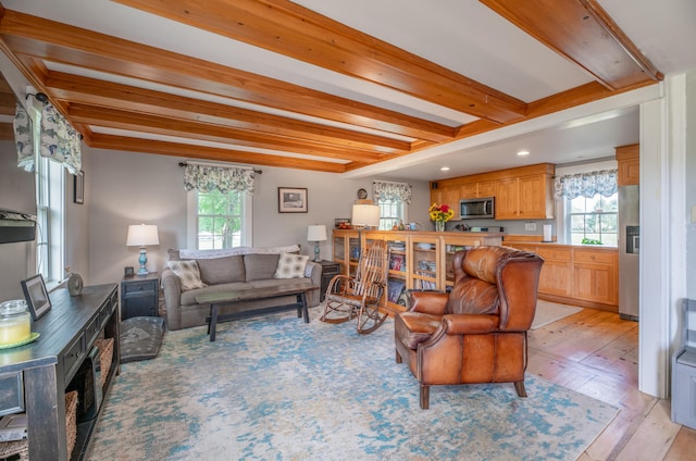 living room with light wood-type flooring and beamed ceiling