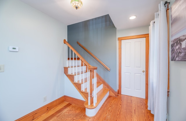 staircase with hardwood / wood-style floors