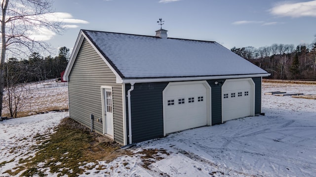 view of snow covered garage