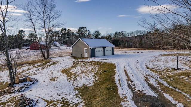 snowy yard with an outbuilding and a garage