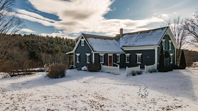 view of snow covered rear of property