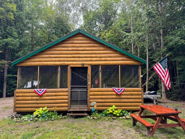 view of outdoor structure featuring a sunroom