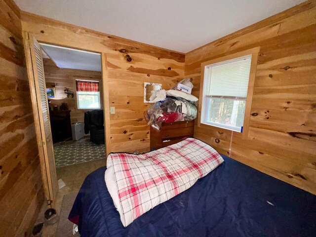 bedroom with wood walls