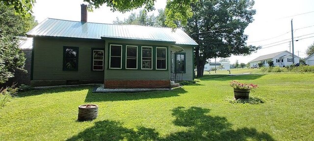 back of house with a lawn