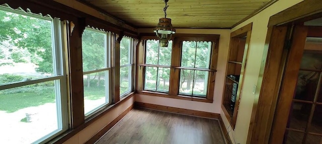 unfurnished sunroom with wood ceiling and plenty of natural light