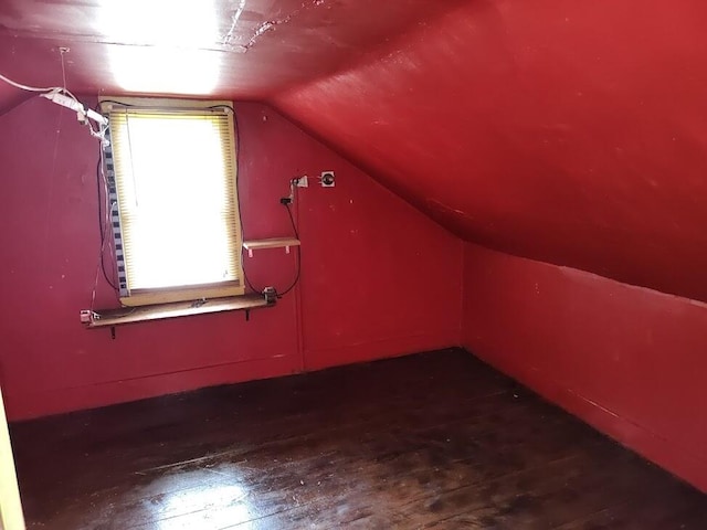 bonus room with lofted ceiling and wood-type flooring