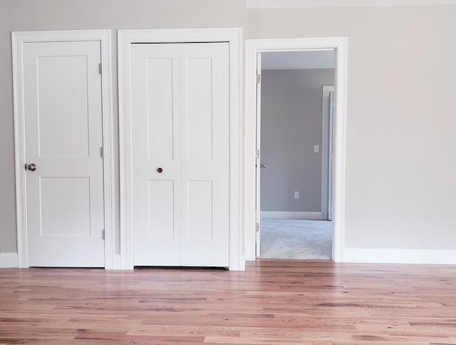 unfurnished bedroom with light colored carpet