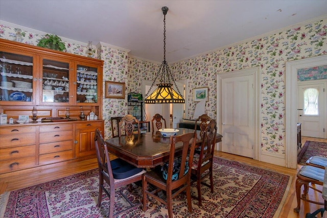 292300 Main Rd, Islesboro, ME 04848 - dining space featuring wallpapered walls, crown molding, and light wood-style floors