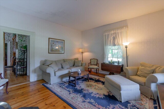 living room with a baseboard radiator and hardwood / wood-style flooring