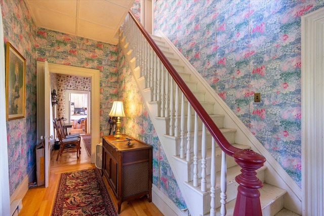 292300 Main Rd, Islesboro, ME 04848 - stairs featuring wallpapered walls, wood finished floors, and baseboard heating