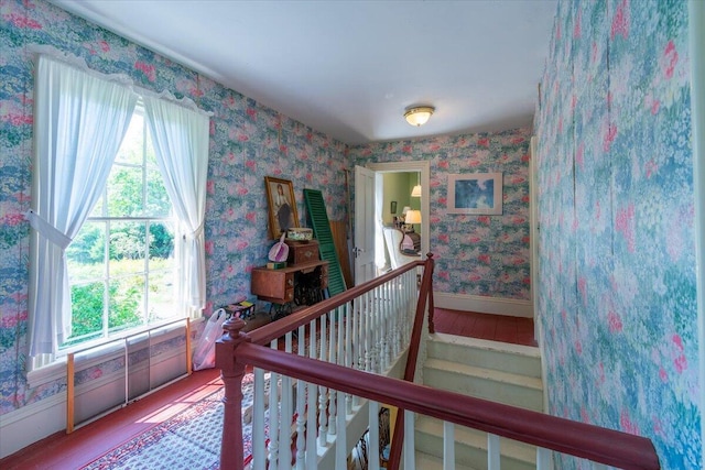 292300 Main Rd, Islesboro, ME 04848 - stairs featuring baseboards, wallpapered walls, wood finished floors, and plenty of natural light