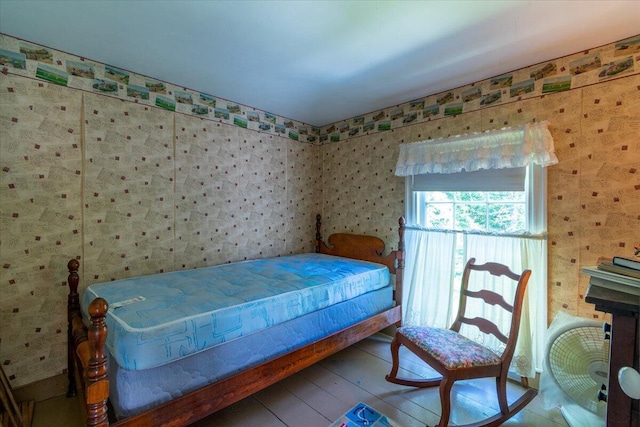 292300 Main Rd, Islesboro, ME 04848 - bedroom featuring wallpapered walls and wood finished floors