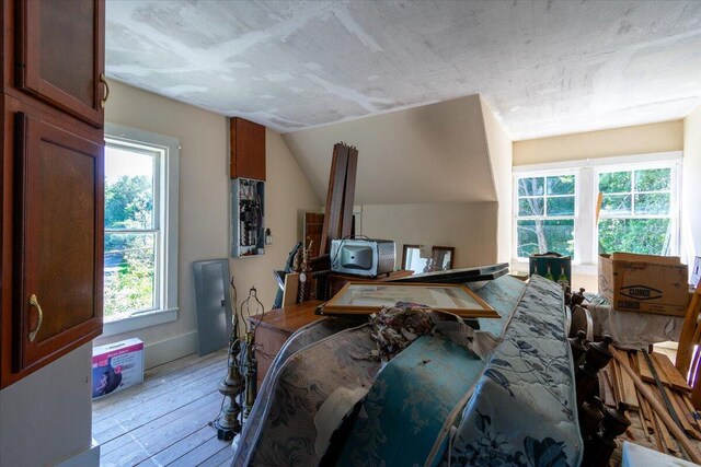 bedroom featuring light wood-type flooring and vaulted ceiling