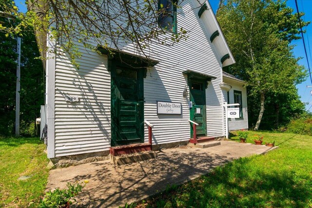 back of house with a lawn