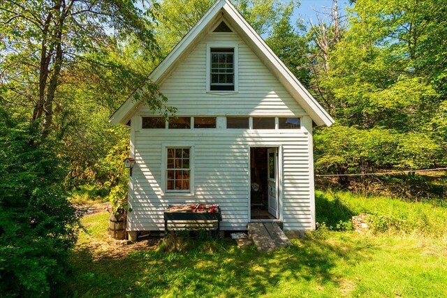 back of house with an outbuilding