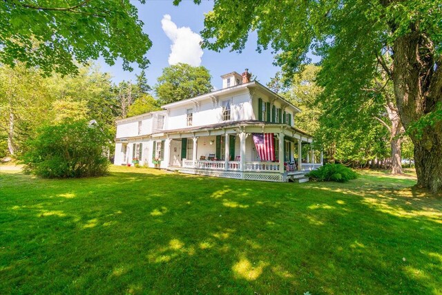 back of house featuring a lawn