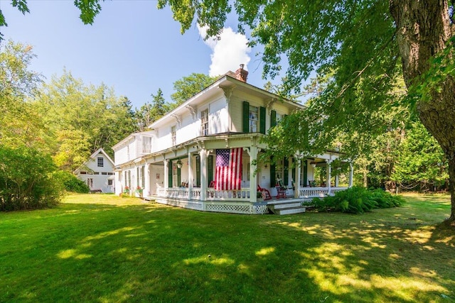 292300 Main Rd, Islesboro, ME 04848 - rear view of property with a lawn, a chimney, and a porch