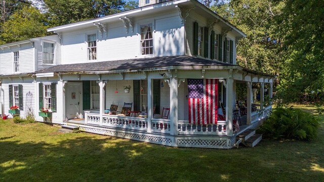 back of house with a yard and a porch