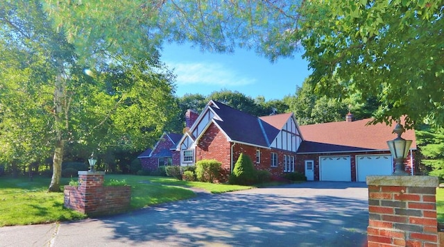 view of front of house with a garage and a front yard