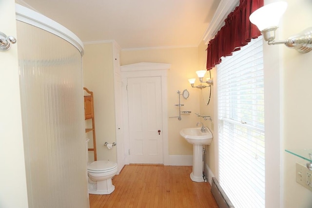 bathroom with wood-type flooring, walk in shower, crown molding, and toilet