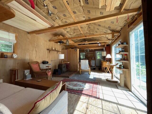 interior space featuring wood walls and lofted ceiling