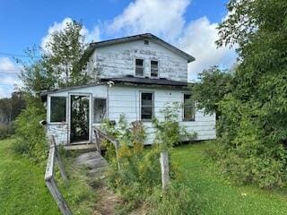 back of property featuring a lawn