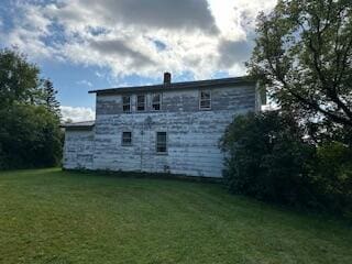 back of property with a lawn