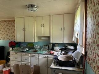 kitchen with wallpapered walls