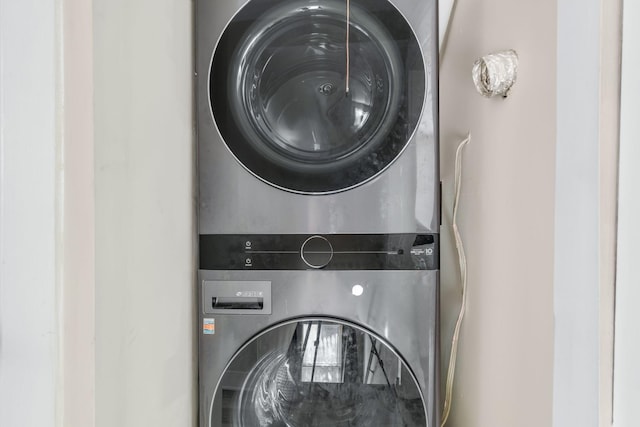 washroom featuring stacked washer and clothes dryer