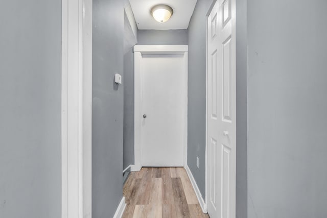 hallway with light hardwood / wood-style floors