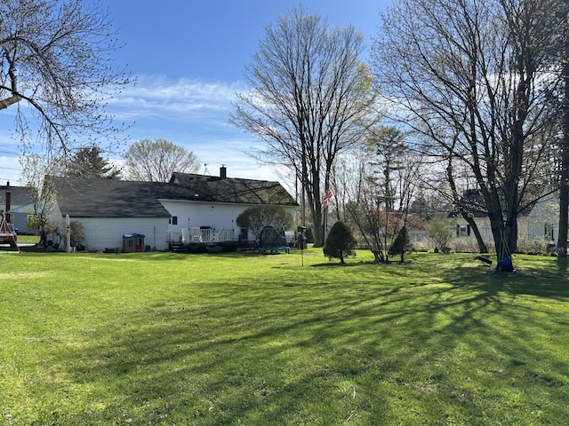 view of yard with a wooden deck and central AC