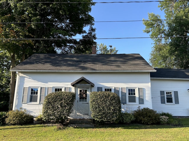 view of front of home featuring a front yard and a chimney