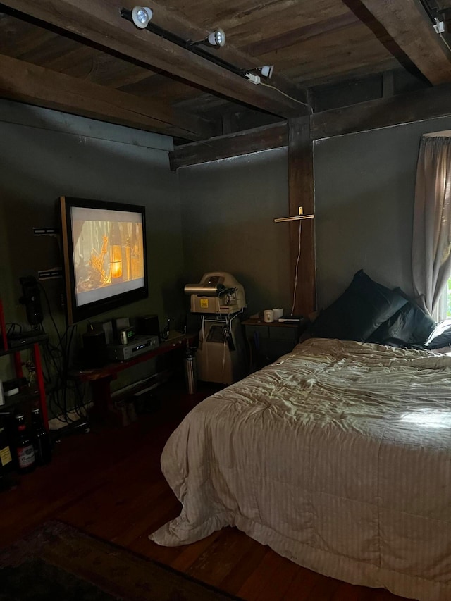 bedroom featuring beamed ceiling and dark hardwood / wood-style flooring