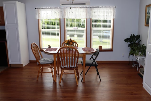 dining room with dark hardwood / wood-style flooring and a healthy amount of sunlight