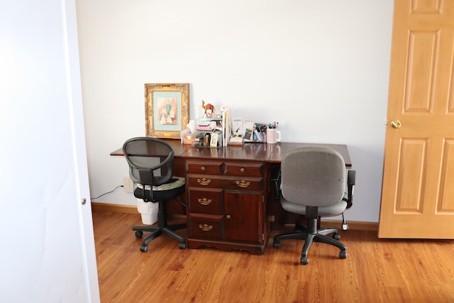 office with light wood-type flooring