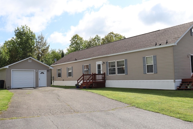 view of front facade featuring an outdoor structure, a garage, and a front yard