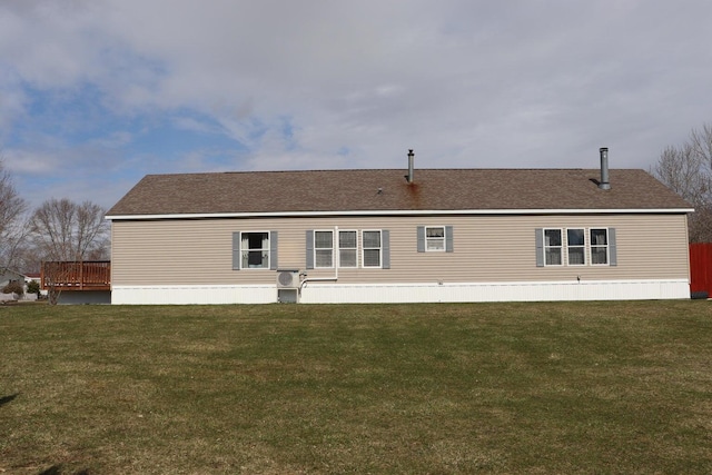 back of house featuring a yard and a wooden deck