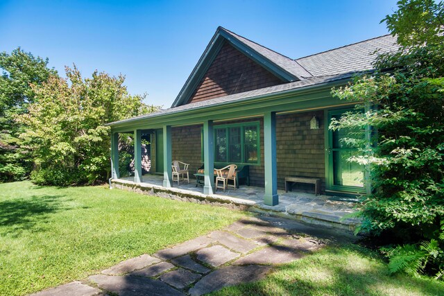41 Sandpiper Ln, Bristol, ME 04539 - back of property featuring a yard, a patio, and a shingled roof