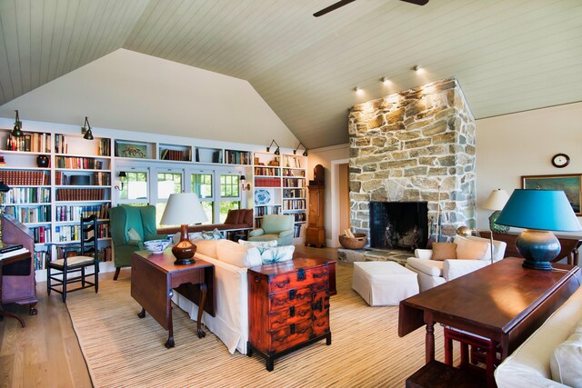 41 Sandpiper Ln, Bristol, ME 04539 - living room featuring vaulted ceiling, a stone fireplace, a ceiling fan, and wood finished floors