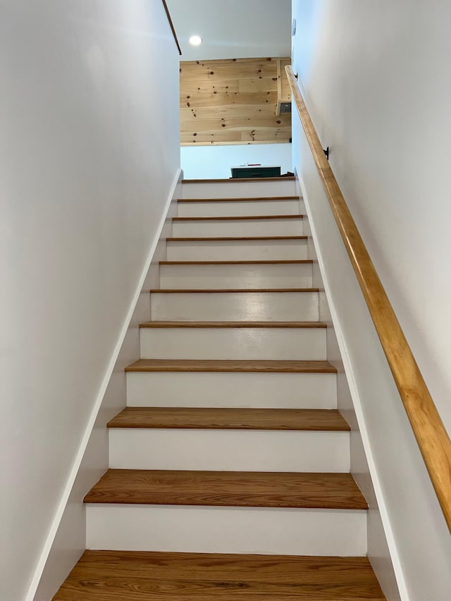 stairs with hardwood / wood-style flooring