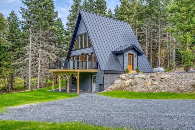 view of front of house with a wooden deck and a front lawn