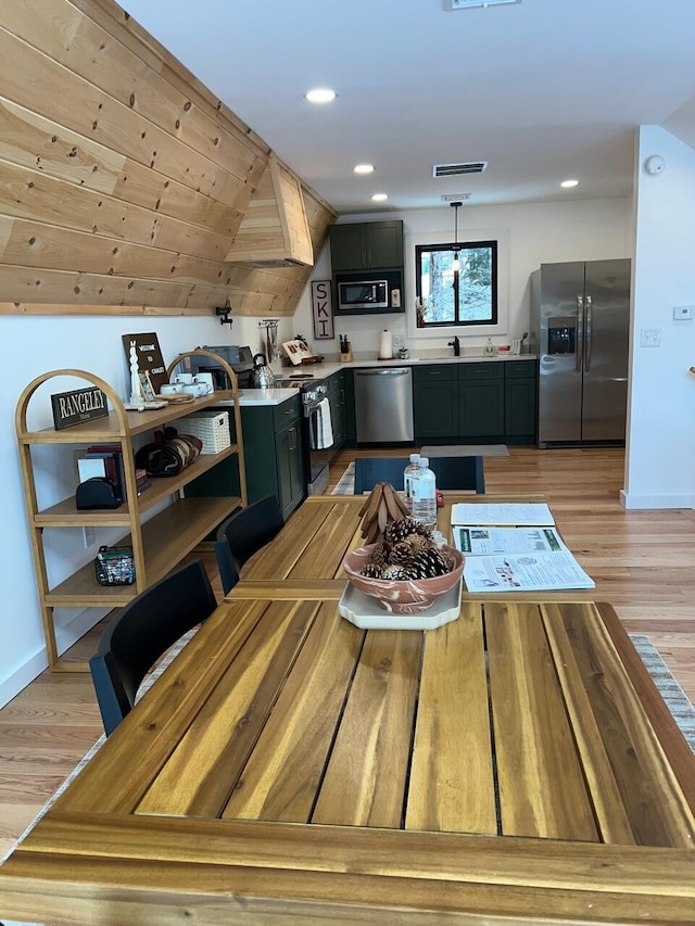 dining area with light hardwood / wood-style floors and sink