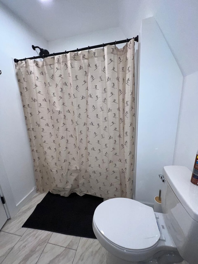 bathroom featuring toilet and walk in shower