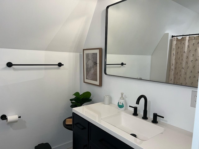 bathroom featuring vanity and vaulted ceiling